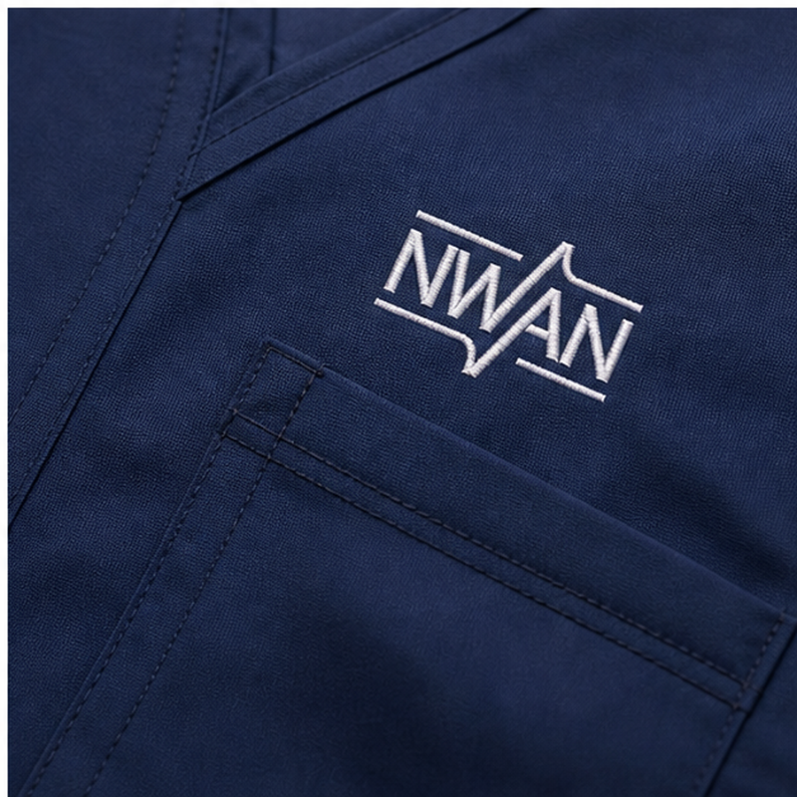 Close up of scrub fabric pocket stitching and embroidered NWAN chest logo